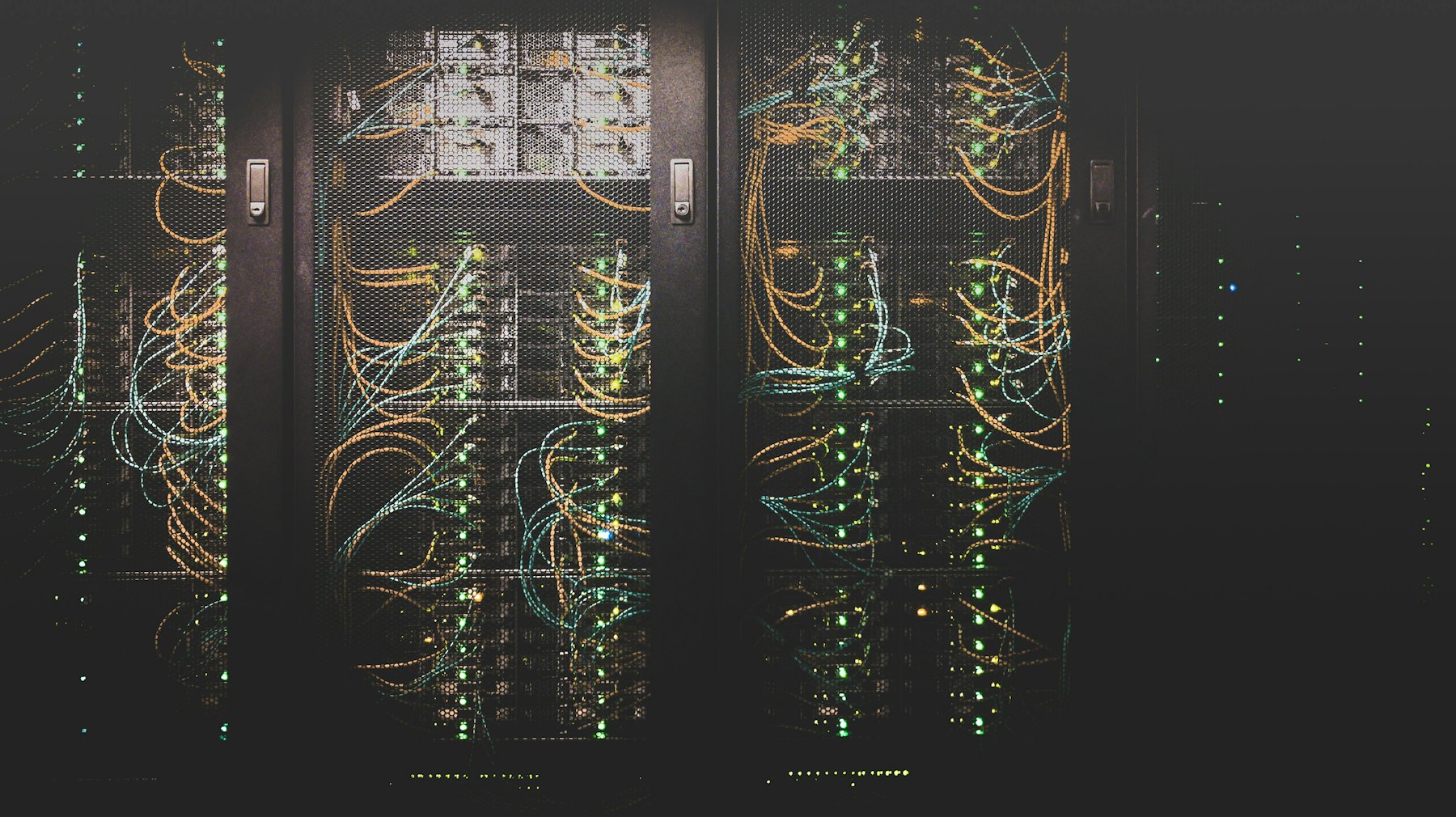 Rows of dark server racks lit by indicator lights
