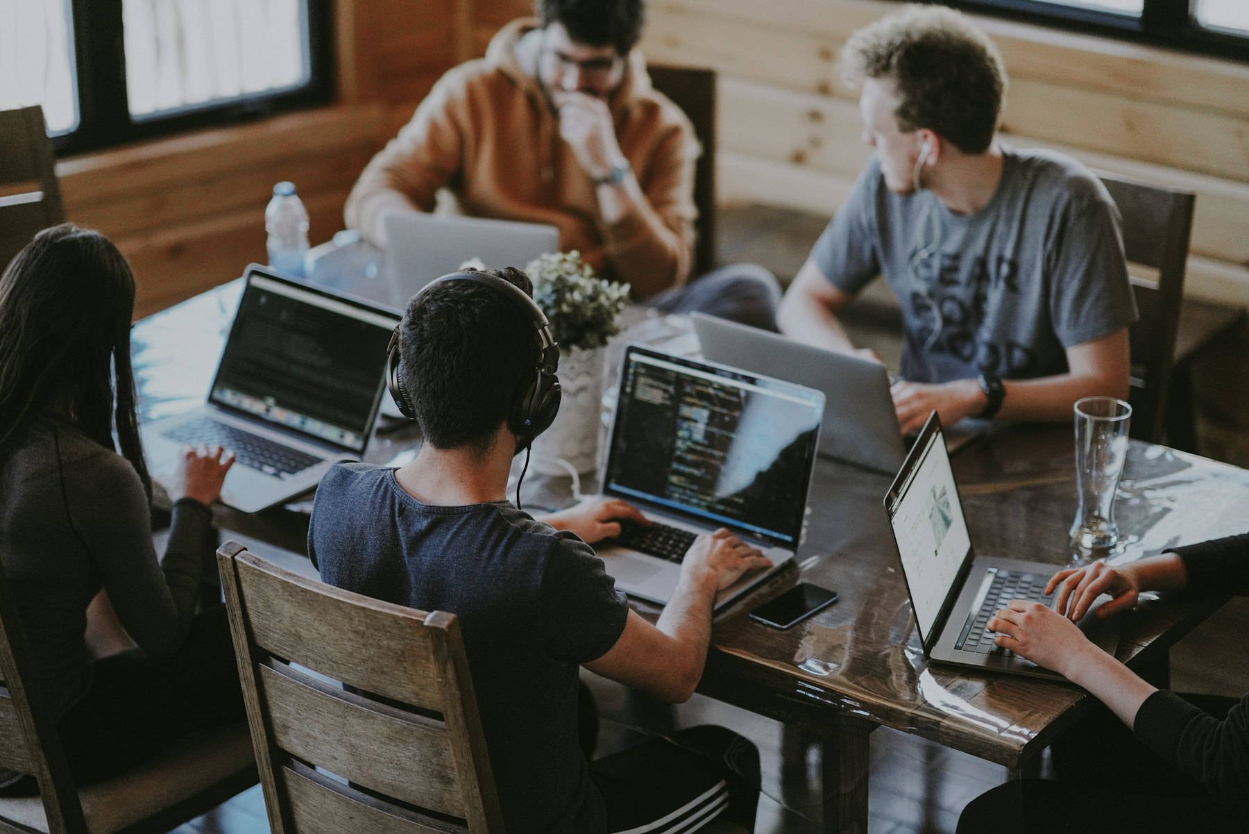 Team working together around a table with laptops